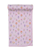 Pink baby blanket with an all-over multicoloured floral pattern and a pink scalloped edge, partially rolled up.