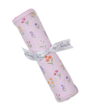 Rolled light lavender blanket with multicolor floral print, pink scalloped trim, tied with a white 'kissy kissy' ribbon.