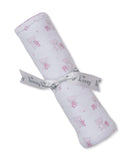 White blanket with repeating light pink teddy bear and heart pattern, pink scalloped trim, tied with a grey ribbon.
