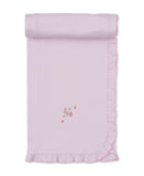 Pink new born blanket with ruffled edges and a small embroidered floral design in the corner.