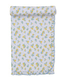 White baby blanket with yellow lemon and blue flower pattern, featuring a light blue ruffled trim.