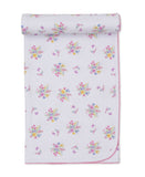 White baby blanket with multicoloured floral and butterfly pattern and pink scalloped trim.