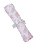 White blanket with pink floral print and green leaves. Tied with a white 'kissy kissy' ribbon. Features a pink ruffled edge.