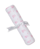 White blanket with a pink teddy bear and small flower pattern, pink stitched edges, tied with a white 'kissy kissy' ribbon.