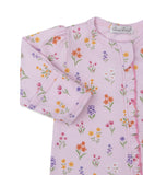 Pink sleepsuit with multicolor floral print, long sleeves, ribbed cuffs, and ruffled trim along the front opening.
