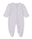 Pink and white patterned baby sleepsuit with long sleeves, integrated feet, and a ruffled snap button placket.