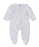 White baby sleepsuit with a pink heart pattern, long sleeves, ruffled trim along the front opening, and integrated feet.