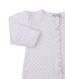 White sleepsuit with small pink heart pattern, pink ruffled trim down the front, and a puffed long sleeve with a folded cuff.