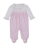 White and light pink new born girl's sleepsuit with smocked bodice, ruffled neckline, and integrated footed design.