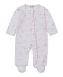 Pink and white baby sleepsuit with long sleeves, integrated footies, ruffle trim along the front, and celestial pattern.