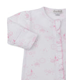 White sleepsuit with pink celestial pattern of stars, suns, moons, and clouds. Features long sleeves with pink cuffs and a ru