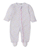 White baby sleepsuit with long sleeves, integrated feet, and all-over pink, blue, yellow heart pattern. Pink ruffle trim on f