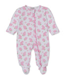 White infant sleepsuit with pink floral print and pink ruffle trim down the front.