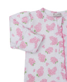 White sleepsuit with pink floral print and green leaves. Features a pink ruffled trim, gathered shoulder, and cuffed wrist.