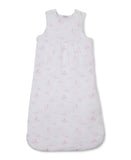 Pink and white baby nest with a celestial print of moons, stars, and clouds, featuring a sleeveless design and side zip.