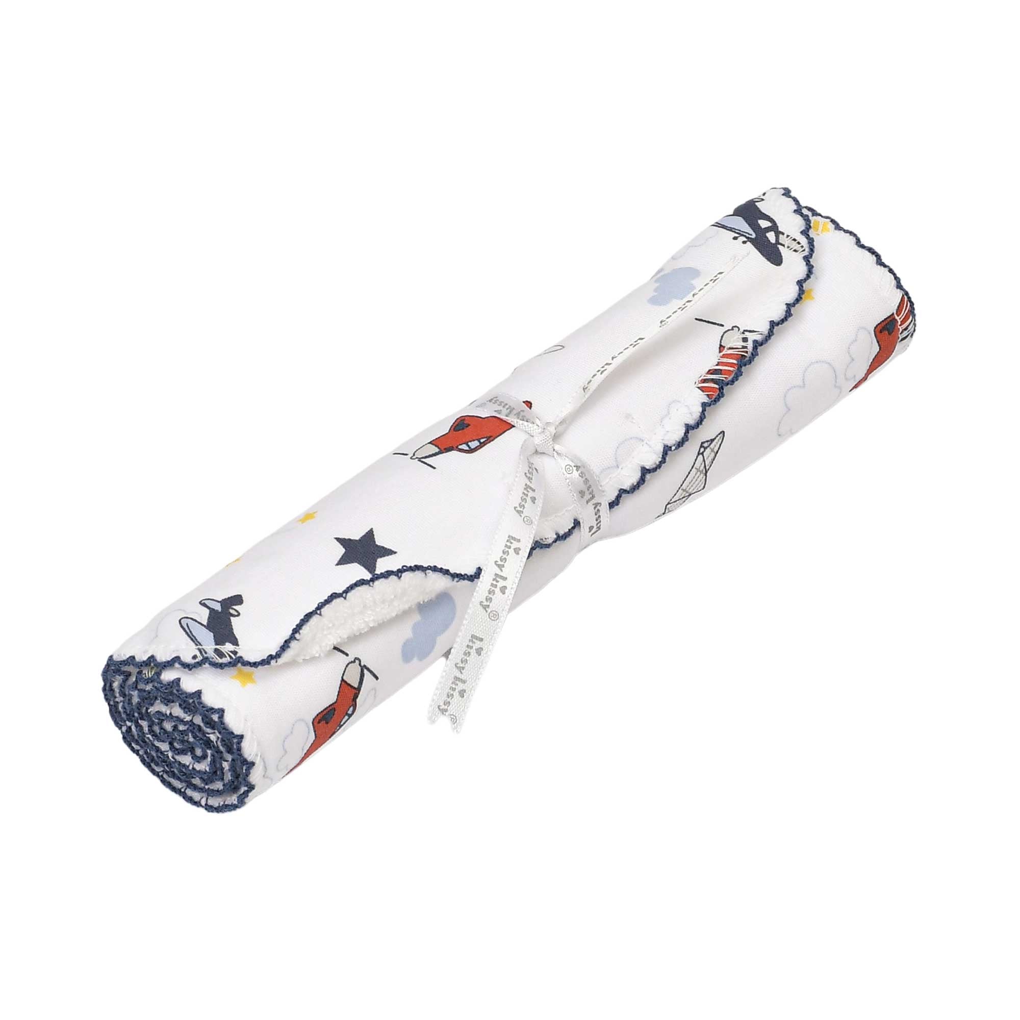 Rolled white fabric with red airplane, blue cloud, and dark blue star print. Scalloped dark blue edges, tied with a white 'ki
