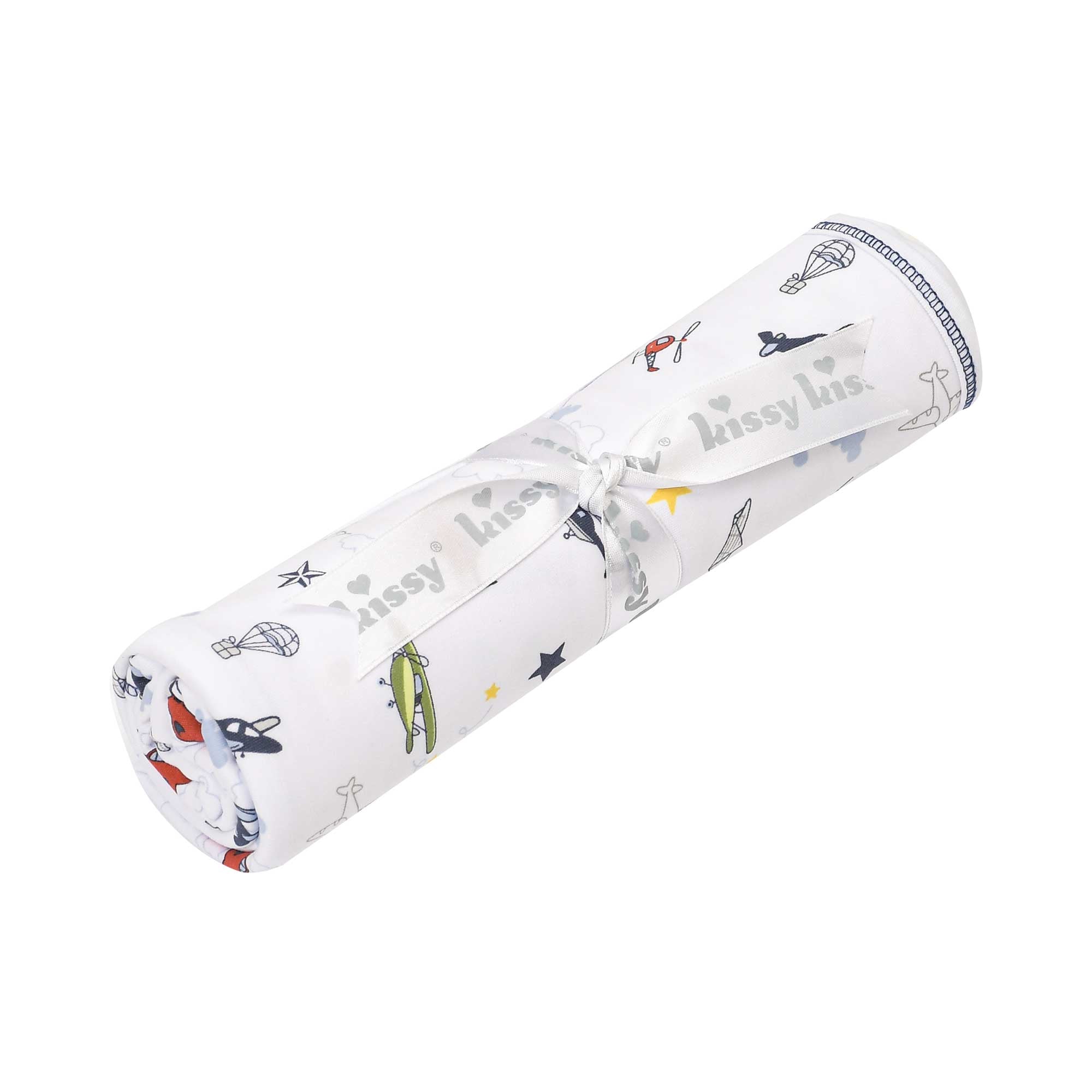 Rolled white fabric with multi-colored aircraft and star pattern, tied with a white 'kissy kiss' ribbon. Blue stitched edge.
