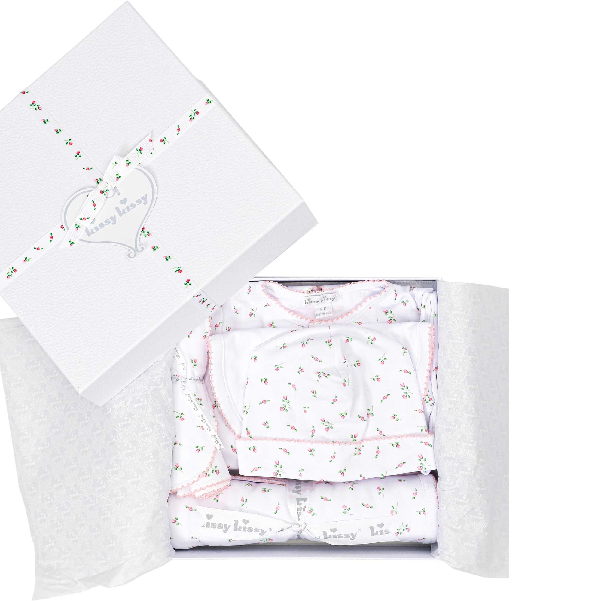 White gift box with a white ribbon, pink floral print, and heart tag. Inside: white baby garments with pink floral print and