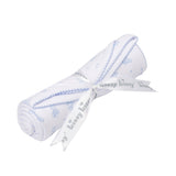 White baby blanket with light blue teddy bear and star print, light blue scalloped trim, rolled and tied with a white 'kissy