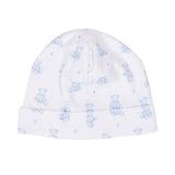 White baby beanie with a folded brim, featuring an allover print of light blue teddy bears and small paw prints.