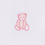 White sleepsuit with a pink embroidered sitting teddy bear detail. The bear has white outlines on its paws and snout.