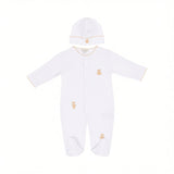 White baby sleepsuit with long sleeves, footed design, and teddy bear embroidery, paired with a matching white beanie hat.