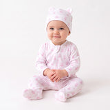 Pink footed sleepsuit with long sleeves, front zipper, and allover teddy bear print. Matching pink beanie with ears and teddy
