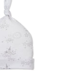 White baby beanie with a knotted top and folded brim, featuring an allover grey print of sleeping clouds, suns, moons, and st