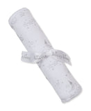 White blanket rolled up, featuring a grey pattern of stars, moons with party hats, clouds, and suns. Tied with a white "kissy