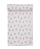 Tan and white blanket with an all-over print of teddy bears and paw prints, featuring a scalloped tan edge.