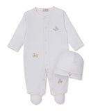 White long-sleeved, footed baby sleepsuit with yellow scalloped trim and embroidered ducklings, paired with a matching white