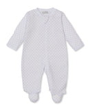White baby sleepsuit with long sleeves, integrated feet, and a full-length front zip, patterned with small tan stars.