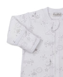 White sleepsuit with silver-colored celestial print of sleeping moons, suns, clouds, and stars. Front zipper, ribbed cuffs.