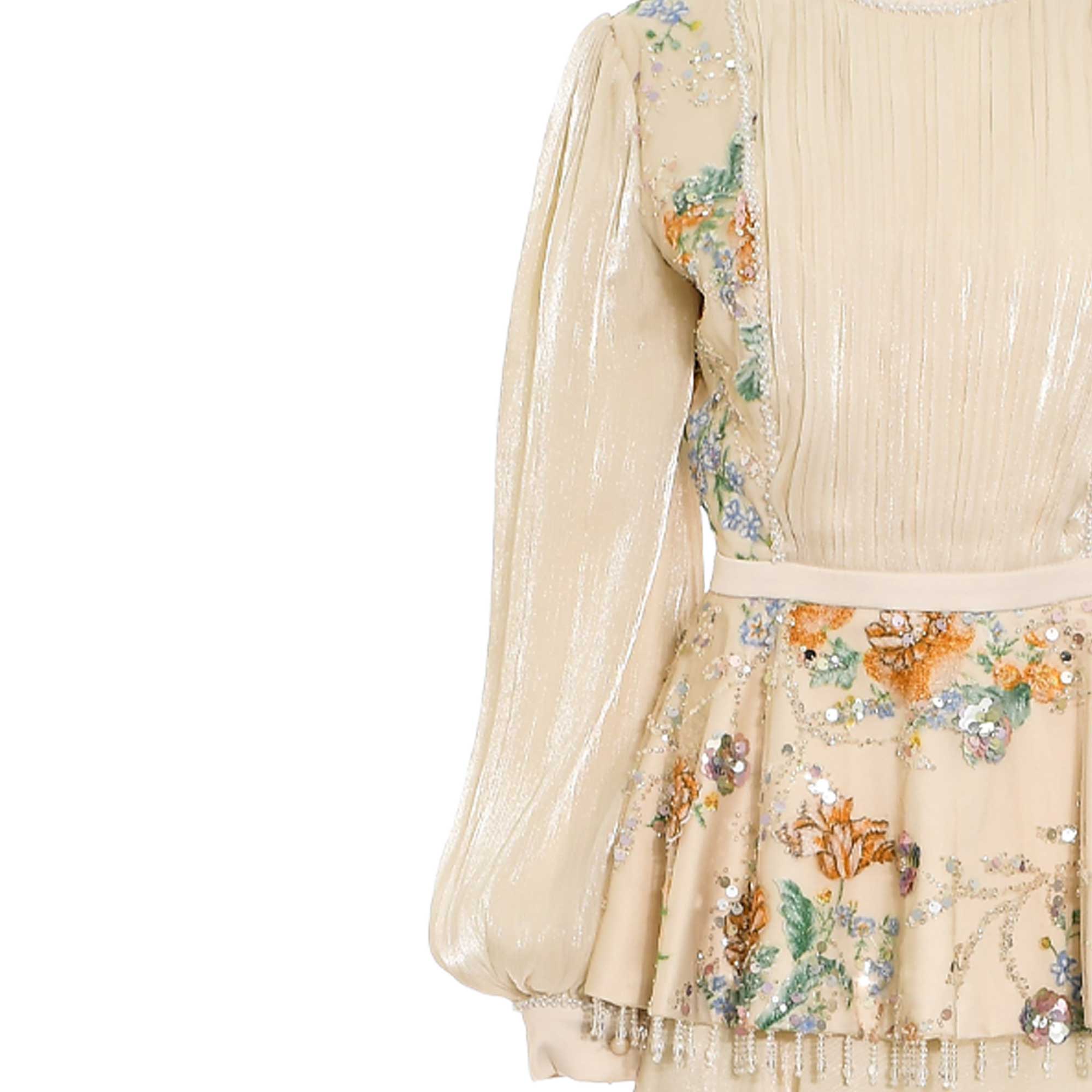 Beige shimmery pleated top with voluminous sleeves, floral sequin details. Skirt features floral sequin details and beaded fr