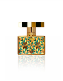 Rear view of the Kajal Kolada perfume bottle showcasing the full-surface colorful geometric mosaic pattern on a gold base.