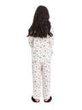 Full-length back studio shot of a young girl wearing the Katee's Kids white wonderland-print silk pajama set, showcasing the relaxed-fit trousers and matching long-sleeve shirt against a solid white background.