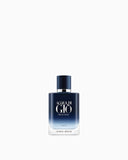 Rectangular glass perfume bottle with rounded edges, transitioning from deep navy blue to clear. Features a navy blue cap and