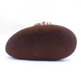 Brown rhinestone embellished oval evening clutch with a gold-toned clasp.