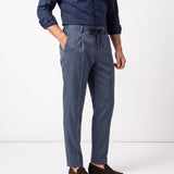 Blue pleated men's trousers with a tapered leg, side pockets, and black drawstring waist.