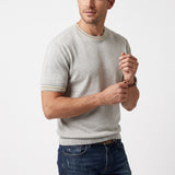 Light grey knit short-sleeved top with a crew neck and striped trim on the collar and cuffs.