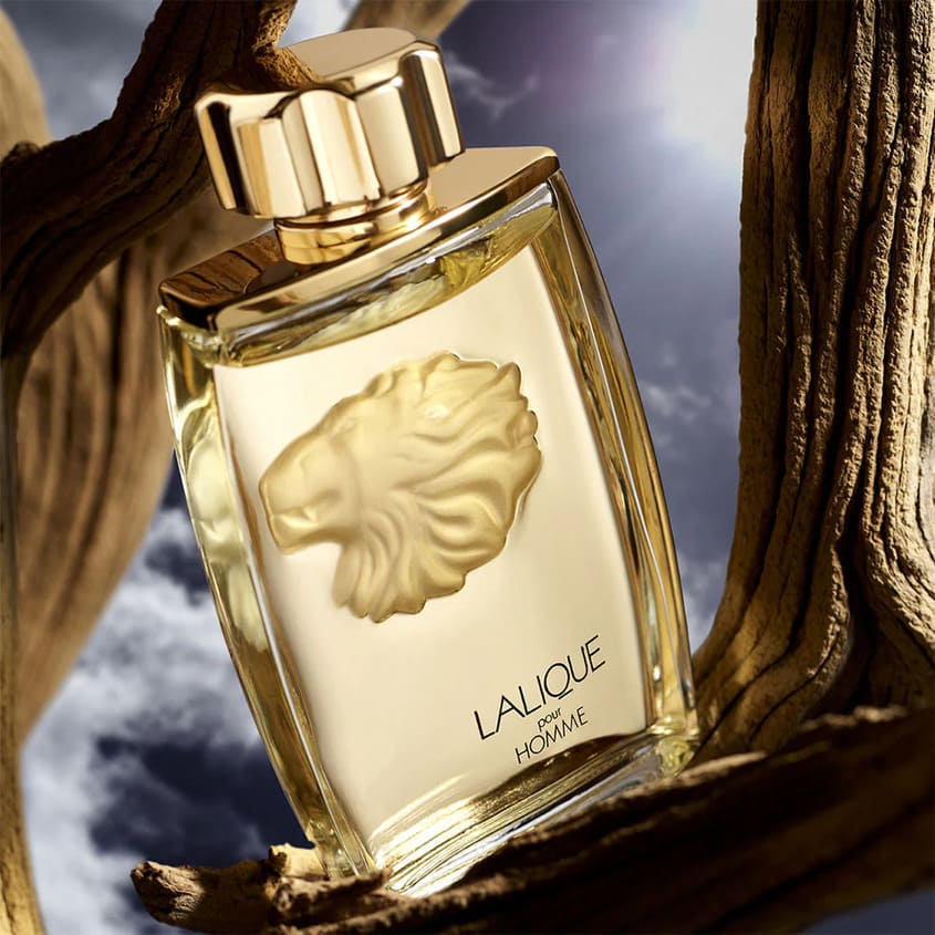 La Lique Pour Homme Lion Eau De Parfum - 125ml Lalique perfume bottle with lion emblem on a wooden surface