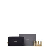 A luxury La Prairie Switzerland skincare set featuring a textured navy blue cosmetic pouch with gold branding, a minimalist grey gift box, and three products from the Pure Gold collection. The set includes a full-size Pure Gold Radiance Cream in a brushed gold jar, accompanied by travel-sized versions of the radiance eye cream and concentrate.