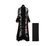 Front view of a LAMAR black velvet abaya featuring a large floral print in pink and blue, with bell sleeves and a matching black Sheila.