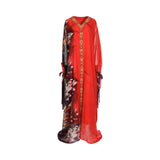 Front view of the LAYLATY red kaftan showing the asymmetrical floral print on the right side and gold crystal trim down the center.