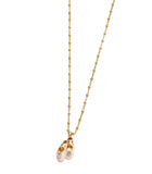 Les Nereides Women's Pink Pallet Slipper Pendant Necklace Gold necklace with a small pendant on a light beige background