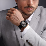 A lifestyle shot of a man wearing the Cerruti 1881 Cuneo chronograph on his wrist, paired elegantly with a light gray tailored suit jacket and white dress shirt.