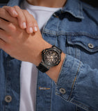 Lifestyle shot of the Police watch PEWGR0082202 on a model's wrist, styled with a casual blue denim jacket over a white t-shirt to emphasize the athletic, transparent design.