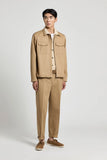 Beige zip-up shirt jacket with a contrasting light beige collar, silver-toned zipper, and two chest flap pockets.