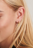 A single gold-toned dangle earring with a small, crystal-encrusted top bar and an elongated oval link.