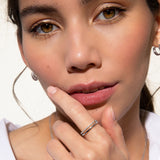 White-plated duo ring with one smooth band and one pavé-set band.